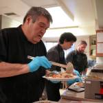 Mark Keel, Coltin Yancey and Chef Stephen Lamm plate and serve the Thanksgiving meal at the Kenai Peninsula Food Bank in Soldotna, Alaska, on Wednesday, Nov. 22, 2023. (Jake Dye/Peninsula Clarion)