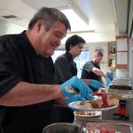 Mark Keel, Coltin Yancey and Chef Stephen Lamm plate and serve the Thanksgiving meal at the Kenai Peninsula Food Bank in Soldotna, Alaska, on Wednesday, Nov. 22, 2023. (Jake Dye/Peninsula Clarion)