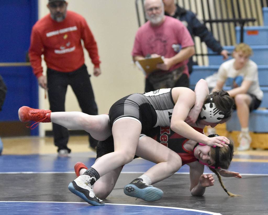 Nikiskis Paisley Maxwell and Kenai Centrals Justyce Stockman battle at 107 pounds Tuesday, Nov. 21, 2023, at Soldotna High School in Soldotna, Alaska. Maxwell won by pin. (Photo by Jeff Helminiak/Peninsula Clarion)