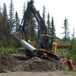 Contractors for the Kenai Peninsula Borough install a culvert at the intersection of Patrick Drive and Bjerke Street to mitigate flooding off of Kalifornsky Beach Road on Friday, July 21, 2023, near Kenai, Alaska. (Ashlyn OHara/Peninsula Clarion)