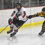 Kenai Centrals Avery Martin controls the puck against Homers Clyde Clemens on Thursday, Nov. 30, 2023, at the Kenai Multi-Purpose Facility in Kenai, Alaska. (Photo by Jeff Helminiak/Peninsula Clarion)