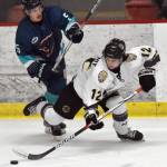 Kenai River Brown Bears defenseman Jacob Margarit keeps the puck from Cole Christian of the Anchorage Wolverines on Friday, Dec. 1, 2023, at the Soldotna Regional Sports Complex in Soldotna, Alaska. (Photo by Jeff Helminiak/Peninsula Clarion)
