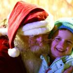 Santa Claus hugs Paul Cook during Christmas in the Park festivities at Soldotna Creek Park in Soldotna, Alaska, on Saturday, Dec. 2, 2023. (Jake Dye/Peninsula Clarion)