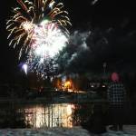 Lindsey, Cody and Lawson Farwell watch fireworks explode over the Kenai River during Christmas in the Park festivities at Soldotna Creek Park in Soldotna, Alaska, on Saturday, Dec. 2, 2023. (Jake Dye/Peninsula Clarion)