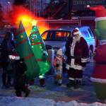 Santa Claus disembarks from a Central Emergency Services firetruck to join Christmas in the Park festivities at Soldotna Creek Park in Soldotna, Alaska, on Saturday, Dec. 2, 2023. (Jake Dye/Peninsula Clarion)