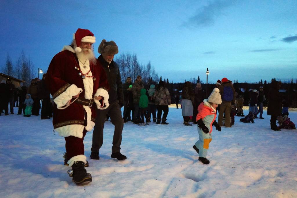 Santa Claus leads the crowd to the tree lighting during Christmas in the Park at Soldotna Creek Park in Soldotna, Alaska, on Saturday, Dec. 2, 2023. (Jake Dye/Peninsula Clarion)