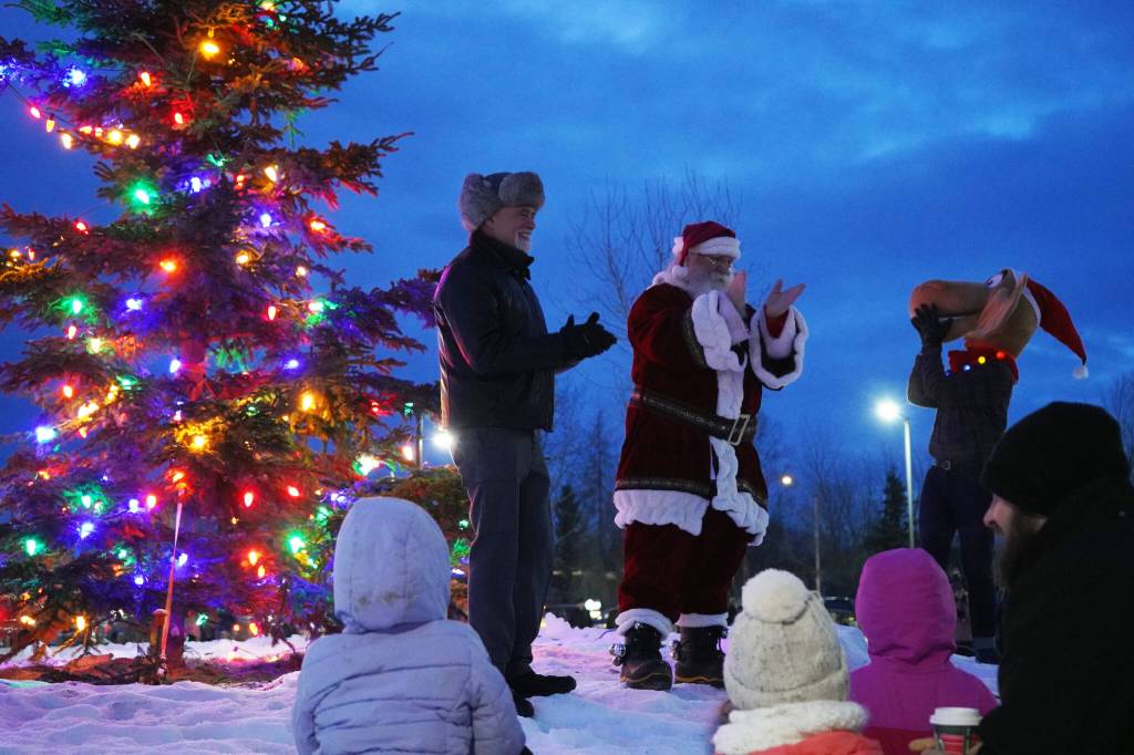 Kenai Peninsula Borough Mayor Peter Micciche, Santa Claus and Nugget ccelebrate the lighting of the tree during Christmas in the Park at Soldotna Creek Park in Soldotna, Alaska, on Saturday, Dec. 2, 2023. (Jake Dye/Peninsula Clarion)