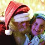 Jake Dye/Peninsula Clarion
Santa Claus hugs Paul Cook during Christmas in the Park festivities at Soldotna Creek Park on Saturday.