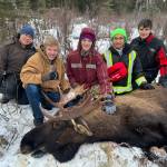 Students sit for a photo with a moose successfully harvested on an educational moose hunt in Nikiski, Alaska, on Saturday, Dec. 2, 2023. (Photo provided by Jesse Bjorkman)