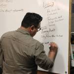 Cook Inletkeeper Community Engagement Coordinator David Knight takes notes about retrofitting homes to be more energy efficient at the Cook Inletkeeper Community Action Studio on Tuesday, Dec. 5, 2023, in Soldotna, Alaska. (Ashlyn OHara/Peninsula Clarion)