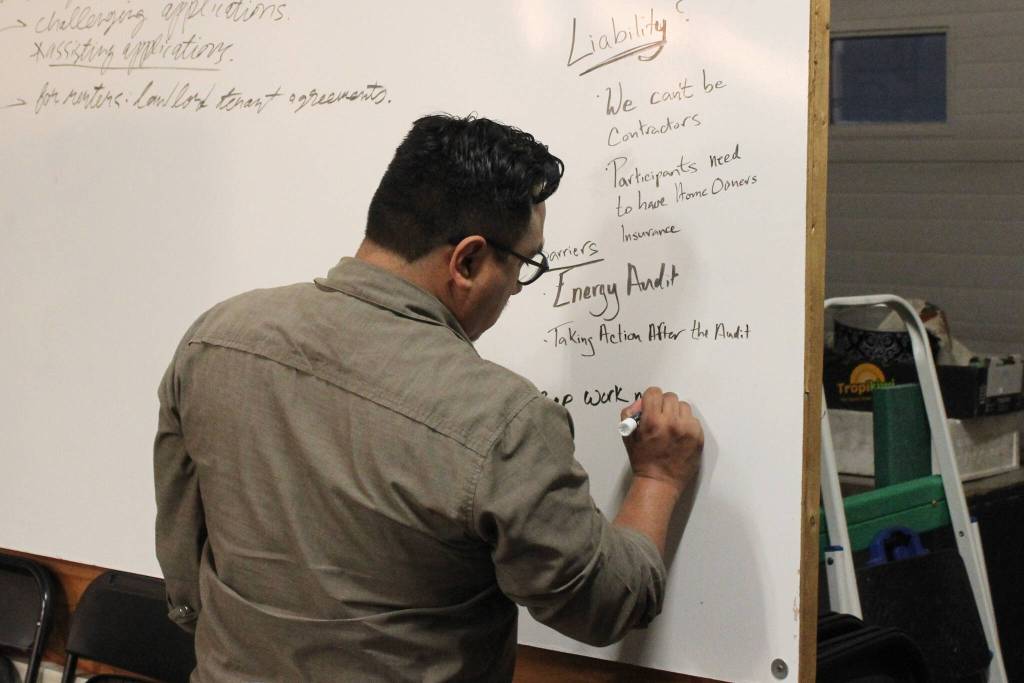 Cook Inletkeeper Community Engagement Coordinator David Knight takes notes about retrofitting homes to be more energy efficient at the Cook Inletkeeper Community Action Studio on Tuesday, Dec. 5, 2023, in Soldotna, Alaska. (Ashlyn OHara/Peninsula Clarion)