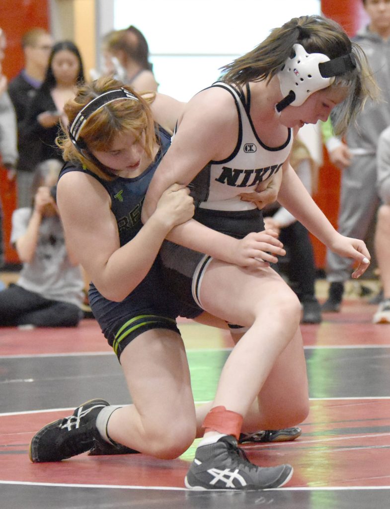Redingtons Alejandra Roman wrestles Nikiskis Addison Perkins in the championship at 138 girls at the Kachemak Conference wrestling tournament at Kenai Central High School in Kenai, Alaska, on Saturday, Dec. 9, 2023. Roman won by pin. (Photo by Jeff Helminiak/Peninsula Clarion)