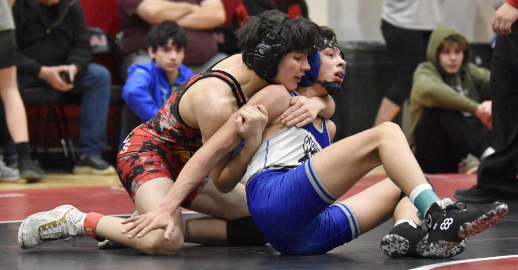 Kenai Centrals Gunnar Stanley and Cordovas Blake Bailey wrestle at 125 pounds at the Kachemak Conference wrestling tournament at Kenai Central High School in Kenai, Alaska, on Saturday, Dec. 9, 2023. Stanley won an 11-10 decision. (Photo by Jeff Helminiak/Peninsula Clarion)