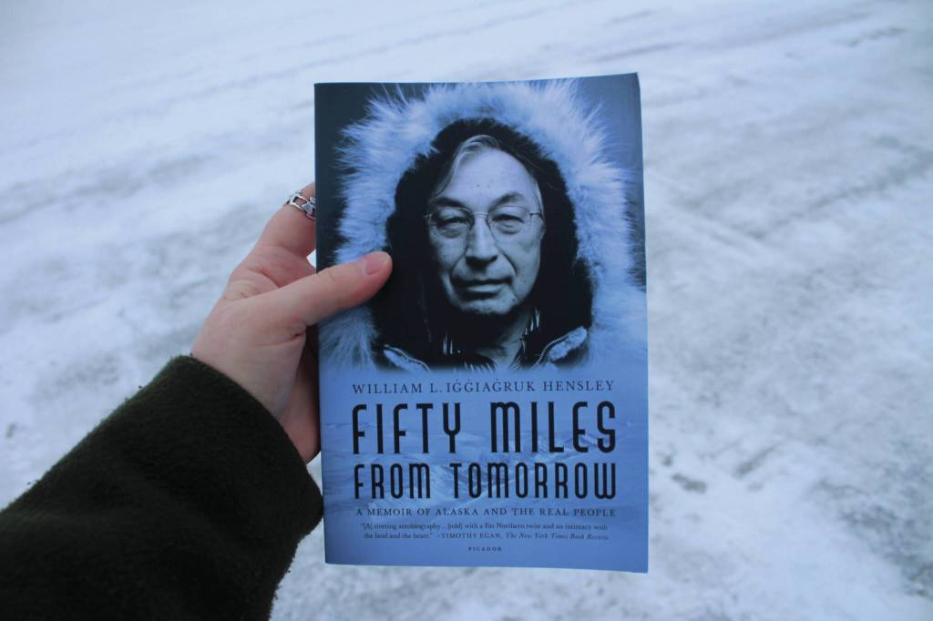 A copy of William L. Iġġiaġruk Hensleys Fifty Miles from Tomorrow is held outside the Peninsula Clarion building on Tuesday, Dec. 12, 2023 in Kenai, Alaska. (Ashlyn OHara/Peninsula Clarion)