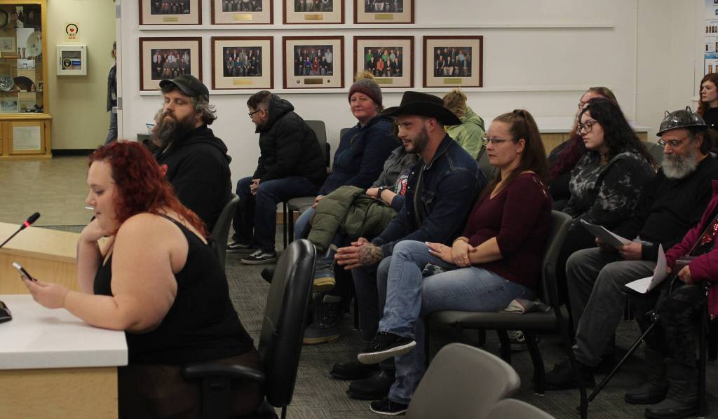 Audience members listen to Iris Fontana, of the Satanic Temple, deliver an invocation during a Kenai Peninsula Borough Assembly meeting on Tuesday, Dec. 12, 2023, in Soldotna, Alaska. Fontana was the last person to deliver an assembly invocation before a new borough policy, which says only borough volunteer chaplains may deliver the invocation, takes effect. (Ashlyn OHara/Peninsula Clarion)