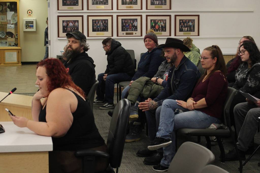 Audience members listen to Iris Fontana, of the Satanic Temple, deliver an invocation during a Kenai Peninsula Borough Assembly meeting on Tuesday, Dec. 12, 2023, in Soldotna, Alaska. Fontana was the last person to deliver an assembly invocation before a new borough policy, which says only borough volunteer chaplains may deliver the invocation, takes effect. (Ashlyn OHara/Peninsula Clarion)
