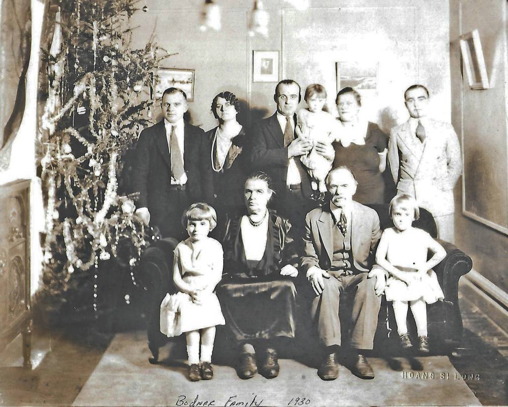 Photo courtesy of the Bodnar Family Collection
Peter and Pearl Bodnar (front, center) pose for a 1930 Christmas portrait with much of their family, probably in Manitoba, Canada. Pictured are: (back row, L-R) Alex, sister Anna (Bodnar) Bandura, brother Michael holding daughter Pearl next to his wife Jessie, and Marcus. In the front row are: Michaels eldest daughter Olga, parents Parascevies Pearl and Peter Bodnar, and Michaels middle daughter Marion.