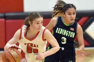 Kenai Central's Sierra Hershberger brings the ball up against Redington's Saydi Cardoso on Thursday, Dec. 14, 2023, at the Craig Jung Tournament at Kenai Central High School in Kenai, Alaska. (Photo by Jeff Helminiak/Peninsula Clarion)