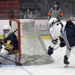 Soldotnas Jace Appelhans stuffs in a goal past Bartlett-East co-op goalie Reece Morton and defender Edwin Maxwell on Friday, Dec. 15, 2023, at the Soldotna Regional Sports Complex in Soldotna, Alaska. (Photo by Jeff Helminiak/Peninsula Clarion)