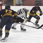 Soldotnas Gehret Medcoff splits Bartlett-East co-op defenders Wyatt Rust and Dylan Beals on Friday, Dec. 15, 2023, at the Soldotna Regional Sports Complex in Soldotna, Alaska. (Photo by Jeff Helminiak/Peninsula Clarion)