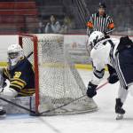 Soldotna's Jace Appelhans stuffs in a goal past Bartlett-East co-op goalie Reece Morton and defender Edwin Maxwell on Friday, Dec. 15, 2023, at the Soldotna Regional Sports Complex in Soldotna, Alaska. (Photo by Jeff Helminiak/Peninsula Clarion)