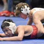 Sewards Tommy Jarnig works his way to a technical fall over Chevaks Laiton Pingayak in the Division II final at 103 pounds Saturday, Dec. 16, 2023, at the state wrestling tournament at the Alaska Airlines Center in Anchorage, Alaska. (Photo by Jeff Helminiak/Peninsula Clarion)