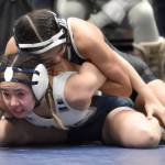 Soldotnas Jessica LeClair works her way to a pin of Wasillas Kaelynn Seidl in the girls finals at 100 pounds Saturday, Dec. 16, 2023, at the state wrestling tournament at the Alaska Airlines Center in Anchorage, Alaska. (Photo by Jeff Helminiak/Peninsula Clarion)