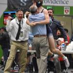 Soldotnas Trevor Michael hugs Soldotna head coach Pete Dickinson as assistants Max LeClair and Phil Leck celebrate. Michael won the Division I state title at 152 pounds by pinning Souths Zane Gerlach on Saturday, Dec. 16, 2023, at the state wrestling tournament at the Alaska Airlines Center in Anchorage, Alaska. (Photo by Jeff Helminiak/Peninsula Clarion)