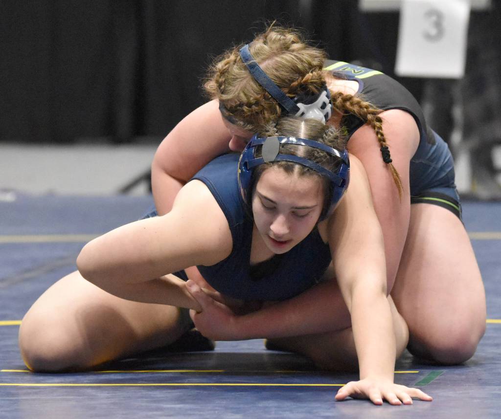 Homers Roane Cook works her way to a pin of Redingtons Nikayla Miller at 185 pounds at the girls tournament Saturday, Dec. 16, 2023, at the state wrestling tournament at the Alaska Airlines Center in Anchorage, Alaska. (Photo by Jeff Helminiak/Peninsula Clarion)