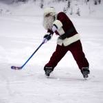 Santa Claus joins children for some hockey action during A Day with the Clauses festivities at Daubenspeck Park in Kenai, Alaska, on Monday, Dec. 18, 2023. (Jake Dye/Peninsula Clarion)