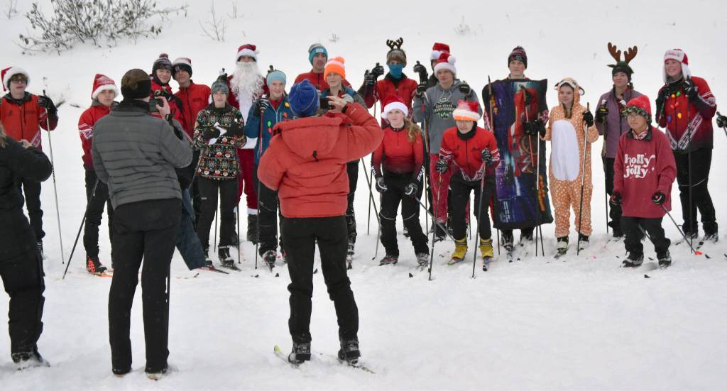 The Kenai Central ski team poses before the start of the Candy Cane Scramble on Friday, Dec. 15, 2023, at Tsalteshi Trails just outside of Soldotna, Alaska. (Photo by Jeff Helminiak/Peninsula Clarion)