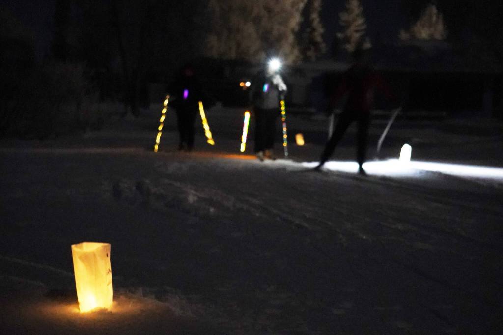 Luminaria light the path of the Third Annual StarLight StarBright winter solstice skiing fundraiser at the Kenai Golf Course in Kenai, Alaska, on Thursday, Dec. 21, 2023. (Jake Dye/Peninsula Clarion)