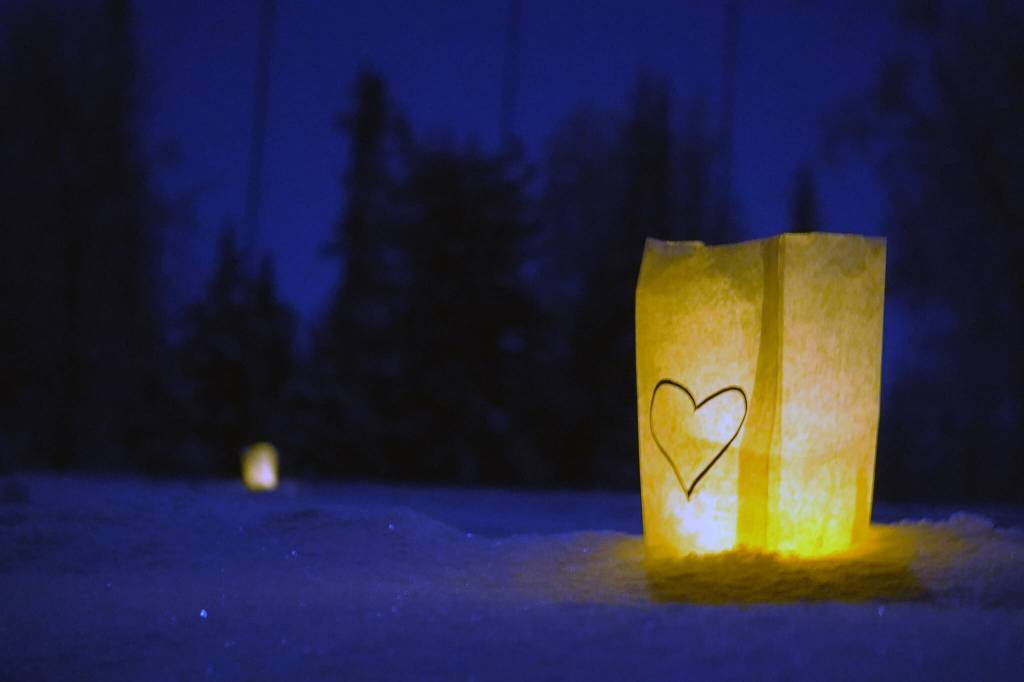 Luminaria light the path of the Third Annual StarLight StarBright winter solstice skiing fundraiser at the Kenai Golf Course in Kenai, Alaska, on Thursday, Dec. 21, 2023. (Jake Dye/Peninsula Clarion)