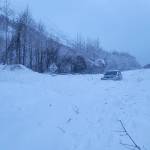 A vehicle is surrounded by avalanche debris along the Seward Highway on Sunday, Dec. 24, 2023, near Cooper Landing, Alaska. (Photo courtesy Alaska Department of Transportation and Public Facilities)