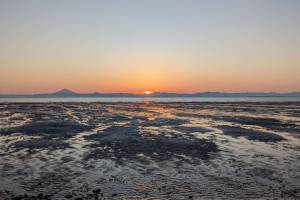 Mount Redoubt volcano can be seen across Cook Inlet from the shores of South Kenai Beach, in Kenai, Alaska, on April 10, 2022. The Alaska Department of Natural Resources in January reported demand for Cook Inlet gas could outpace supply as early as 2027 without additional development in the basins active fields. (Photo by Erin Thompson/Peninsula Clarion)