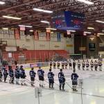 Hockey players in the annual Kenai/Niksiki and SoHi/Skyview alumni hockey game stand for the national anthem at the Soldotna Regional Sports Complex on Friday, Dec. 22, 2023 in Soldotna, Alaska. (Ashlyn OHara/Peninsula Clarion)