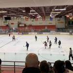 Lower left: 2023 Kenai Central High School alum Gavin Langham (#18) and 2021 Soldotna High School alum Dylan Walton battle over the puck in the second period of the annual Kenai/Nikiski and SoHi/Skyview alumni hockey game at the Soldotna Regional Sports Complex on Friday, Dec. 22, 2023, in Soldotna, Alaska. (Ashlyn OHara/Peninsula Clarion)