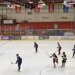 Lower left: 2023 Kenai Central High School alum Gavin Langham (#18) and 2021 Soldotna High School alum Dylan Walton battle over the puck in the second period of the annual Kenai/Nikiski and SoHi/Skyview alumni hockey game at the Soldotna Regional Sports Complex on Friday, Dec. 22, 2023, in Soldotna, Alaska. (Ashlyn OHara/Peninsula Clarion)