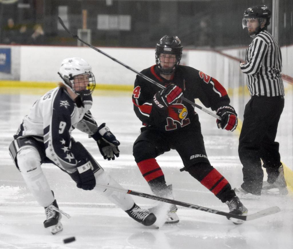 Soldotnas Payton Williams and Kenai Centrals Avery Martin battle for the puck Friday, Jan. 5, 2024, at the Soldotna Regional Sports Complex in Soldotna, Alaska. (Photo by Jeff Helminiak/Peninsula Clarion)