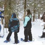 Jake Dye/Peninsula Clarion
Park Ranger Leah Eskelin, right, takes questions while leading a snowshoe walk at the Kenai National Wildlife Refuge near Soldotna on Saturday.