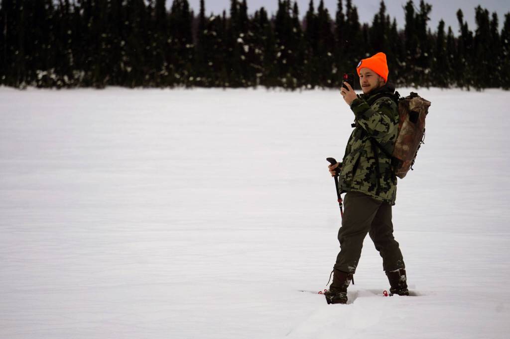 Airk Furseth takes photos while snowshoeing on Headquarters Lake in the Kenai National Wildlife Refuge near Soldotna, Alaska, on Saturday, Jan. 6, 2024. (Jake Dye/Peninsula Clarion)