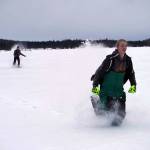 Nathan Teates uses snowshoes to run across Headquarters Lake in the Kenai National Wildlife Refuge, pursued by Isaac Copple, near Soldotna, Alaska, on Saturday, Jan. 6, 2024. (Jake Dye/Peninsula Clarion)