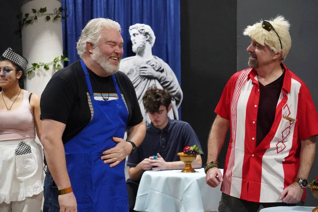 David Brighton portrays Zeus and Todd Sherwood portrays Sparky Guy during a rehearsal of Greece is the Word: The Zeusical at the Kenai Performers Theatre in Soldotna, Alaska, on Saturday, Jan. 6, 2024. (Jake Dye/Peninsula Clarion)