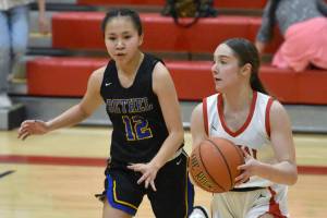Kenai Central's Sierra Hershberger keeps the ball from Bethel's Kyana Harpak on Wednesday, Jan. 10, 2024, at Kenai Central High School in Kenai, Alaska. (Photo by Jeff Helminiak/Peninsula Clarion)