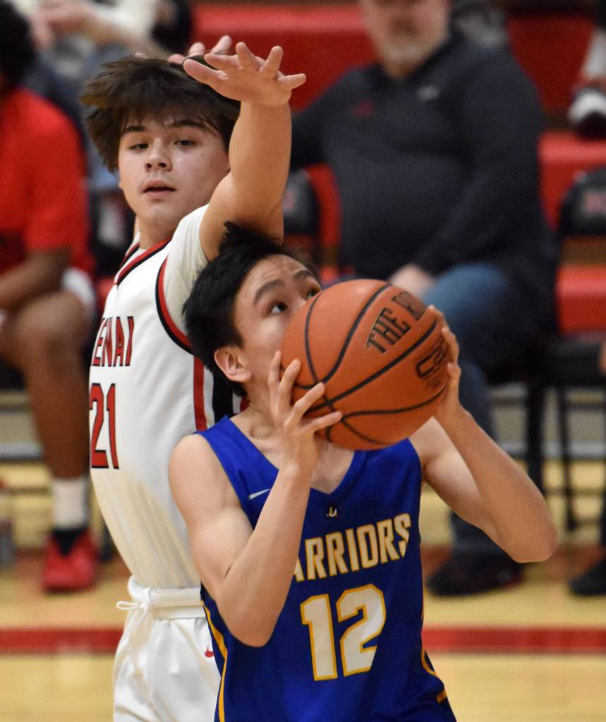 Bethels Aaron Mute drives against Kenai Centrals William Wilson on Wednesday, Jan. 10, 2024, at Kenai Central High School in Kenai, Alaska. (Photo by Jeff Helminiak/Peninsula Clarion)