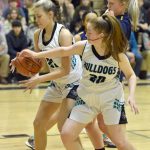 Nikiskis Mandee Roofe and Avery Ellis secure a rebound in front of Homers Sydney Shelby on Friday, Jan. 12, 2024, at Nikiski Middle-High School in Nikiski, Alaska. (Photo by Jeff Helminiak/Peninsula Clarion)