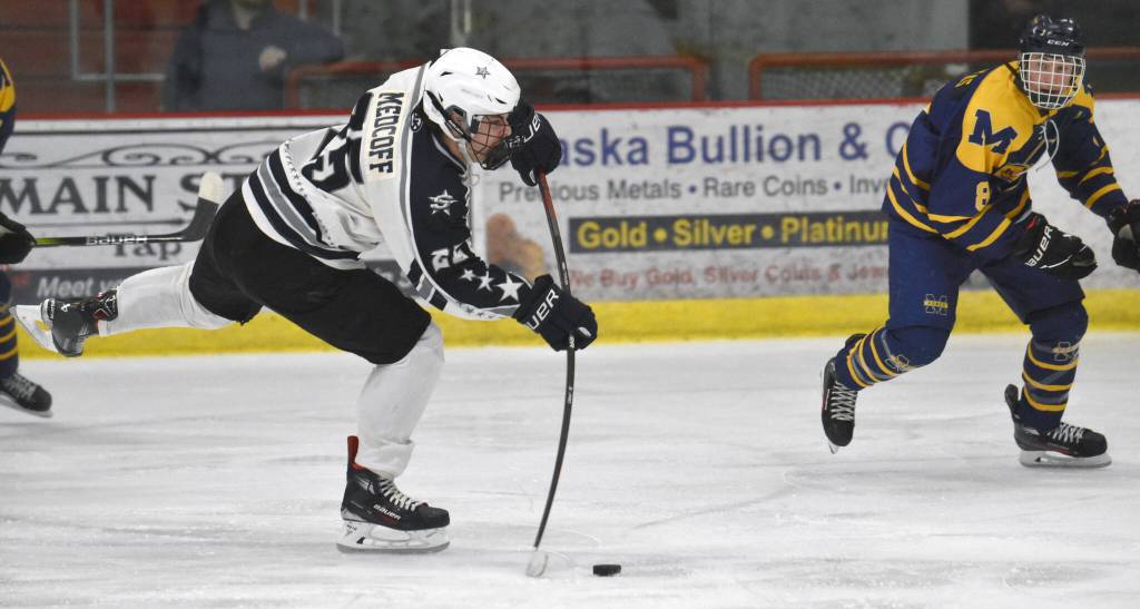 Soldotnas Gehret Medcoff takes a shot in front of Homers Cody Thomas on Thursday, Jan. 18, 2024, at the Soldotna Regional Sports Complex in Soldotna, Alaska. (Photo by Jeff Helminiak/Peninsula Clarion)