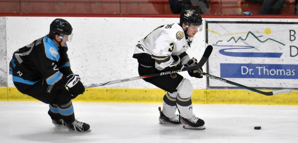 Nick Stevens of the Kenai River Brown Bears protects the puck from Carter Theissen of the Wisconsin Windigo on Saturday, Jan. 20, 2024, at the Soldotna Regional Sports Complex in Soldotna, Alaska. (Photo by Jeff Helminiak/Peninsula Clarion)