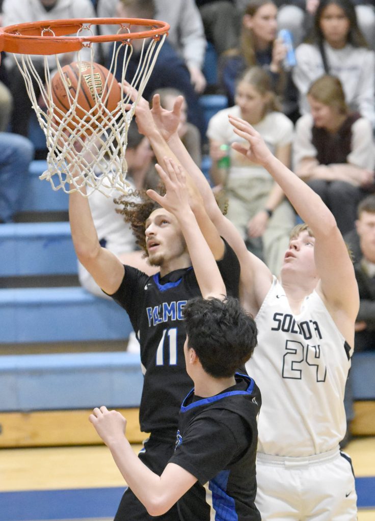 Palmers Isaac Evans grabs a rebound in front of Soldotnas Andrew Pieh at the Revolution Sport and Spine Therapy Al Howard Shootout on Thursday, Jan. 25, 2024, at Soldotna High School in Soldotna, Alaska. (Photo by Jeff Helminiak/Peninsula Clarion)