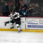 Kenai Rivers Carter McCormick checks Anchorages Christian Theberge away from the puck at the Soldotna Regional Sports Complex in Soldotna, Alaska, on Friday, Jan. 25, 2024. (Jake Dye/Peninsula Clarion)